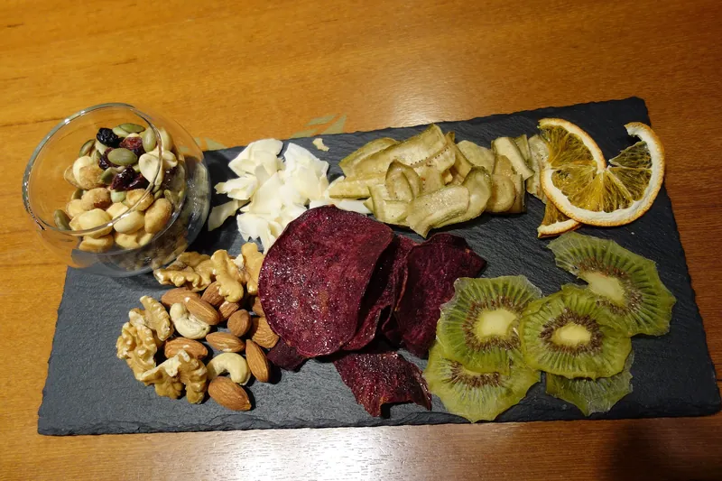 Assortment of dried fruit and nuts on a slate